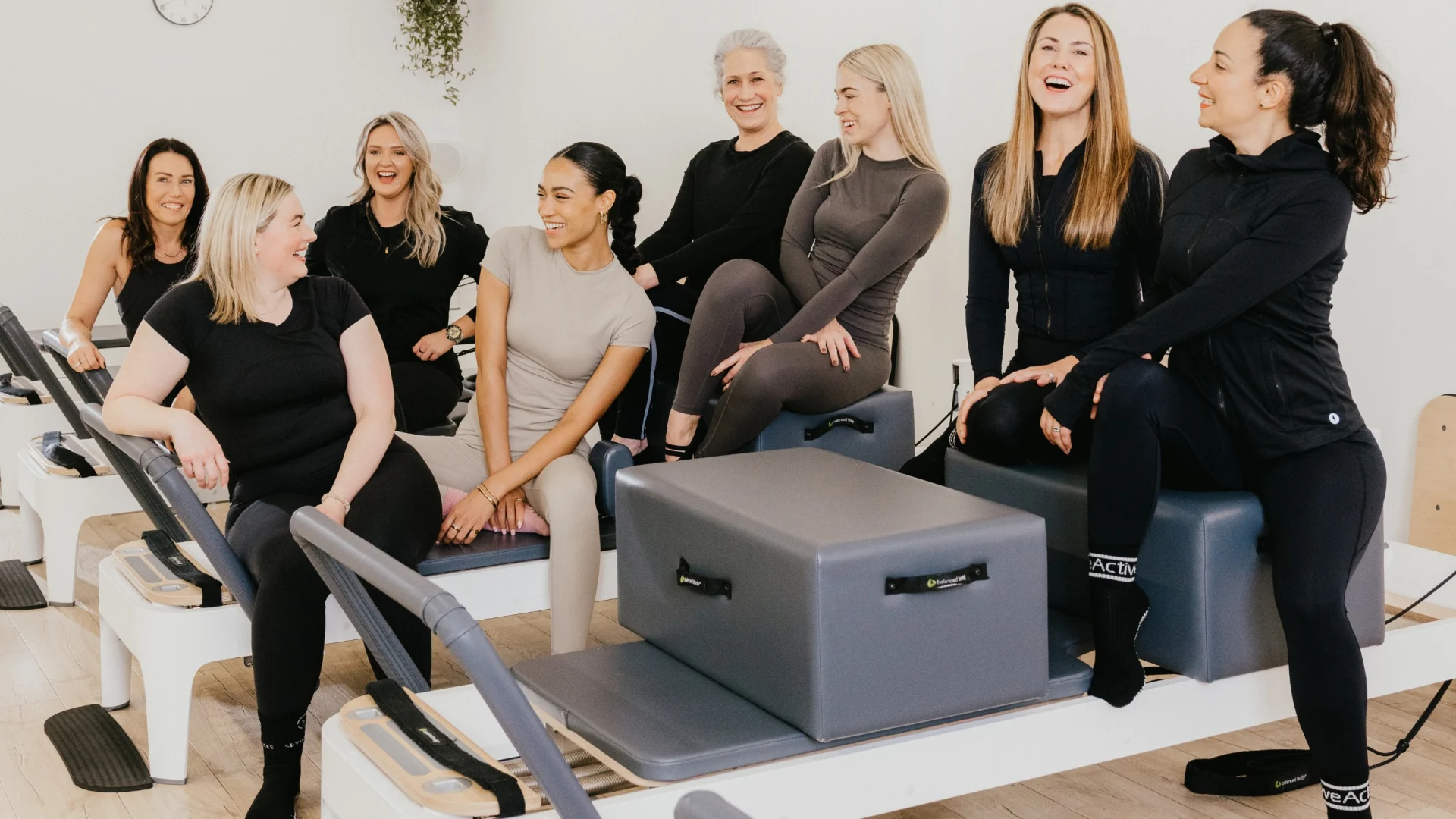 Bright reformer Pilates studio with rows of reformer beds